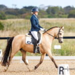 Sinead Conlon riding a dressage test on a buckskin pony Miss Mary Poppins